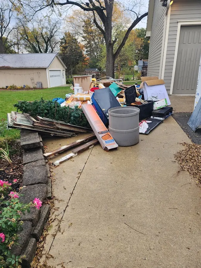 Dumpster being loaded with debris for 3 Yard Dumpster Rental in Chesaning